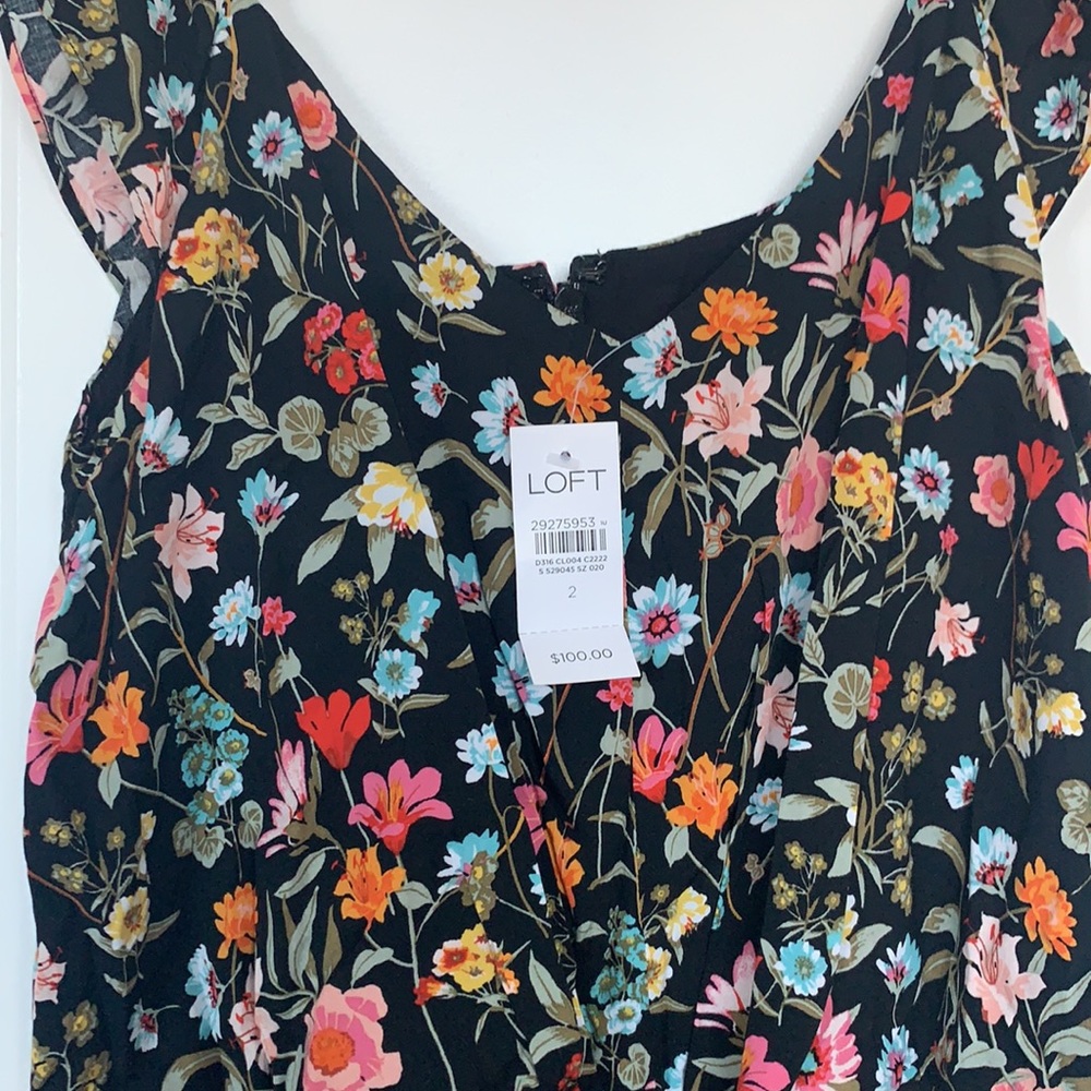 NWT floral jumpsuit with flutter cap sleeves.